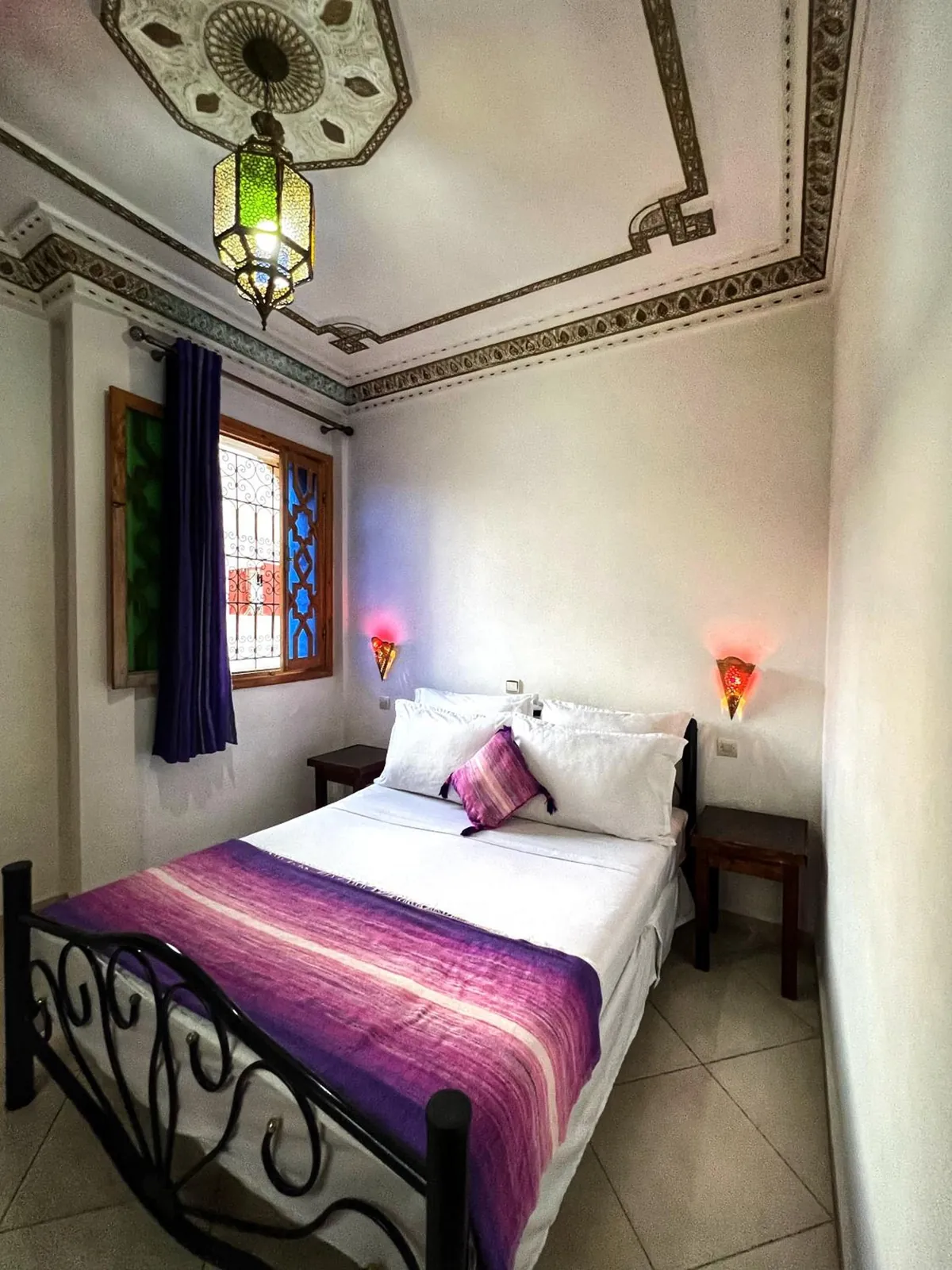 Double room, purple throw and lantern